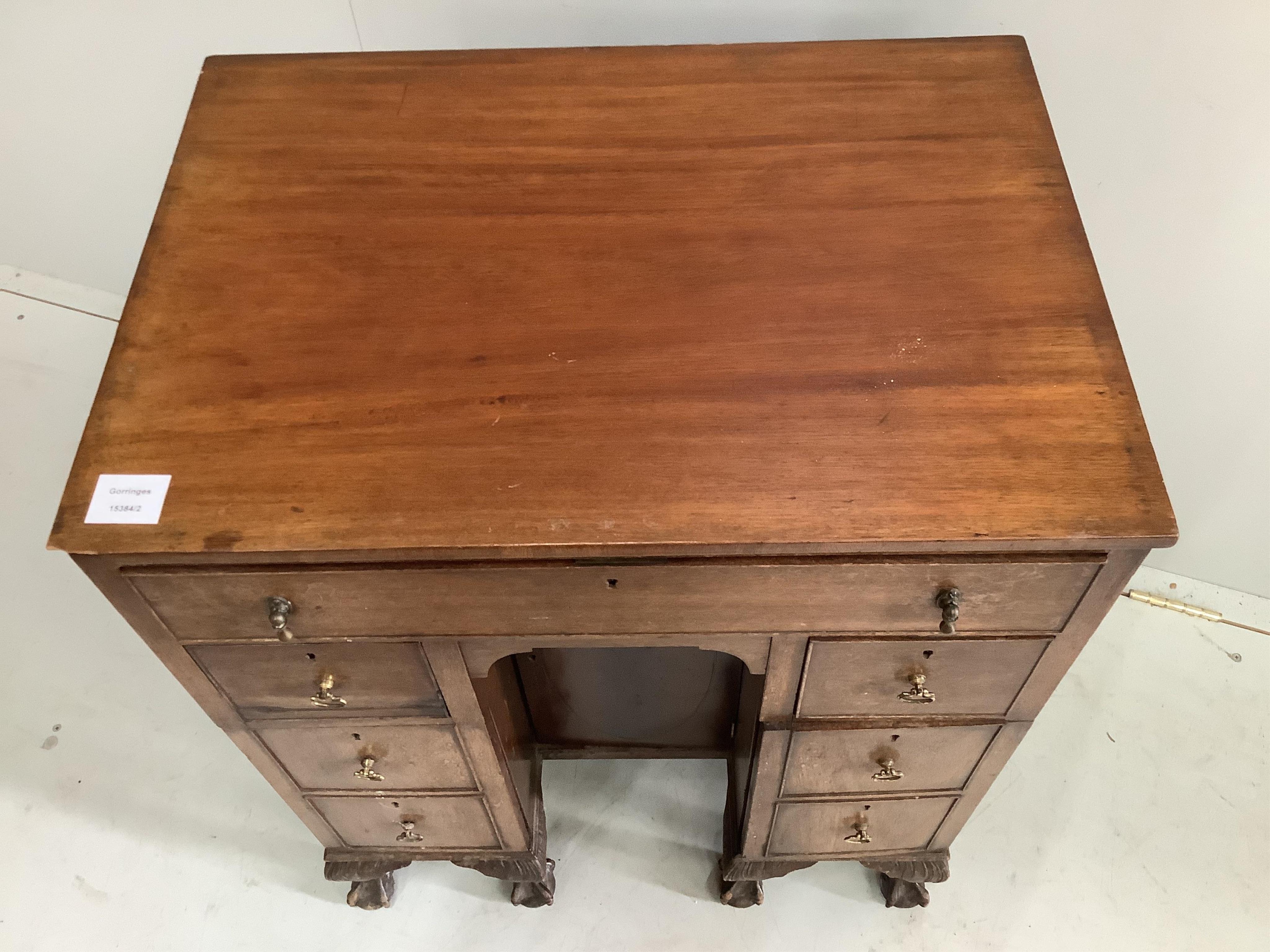 A small George III style mahogany kneehole desk, width 61cm, depth 43cm, height 77cm. Condition - poor to fair